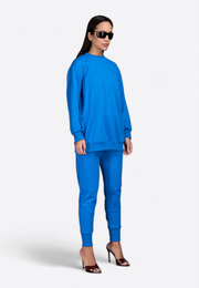 Model wearing crewneck long-sleeve blue sweatshirt, front view – East Vibe
